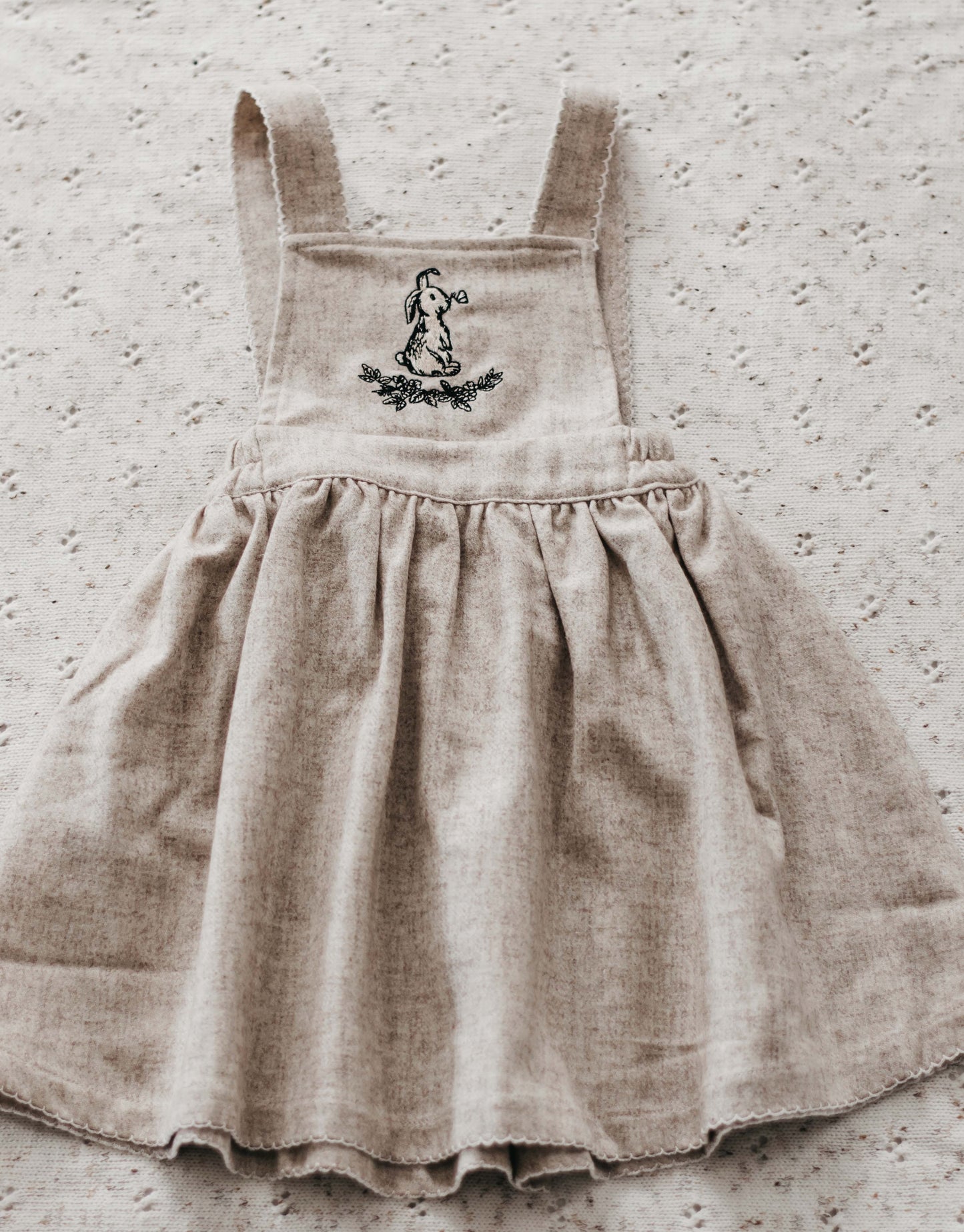 A Bencer and Hazelnut Dress made from Linen in a Oatmeal Colour with a hand drawn little Bunny Print